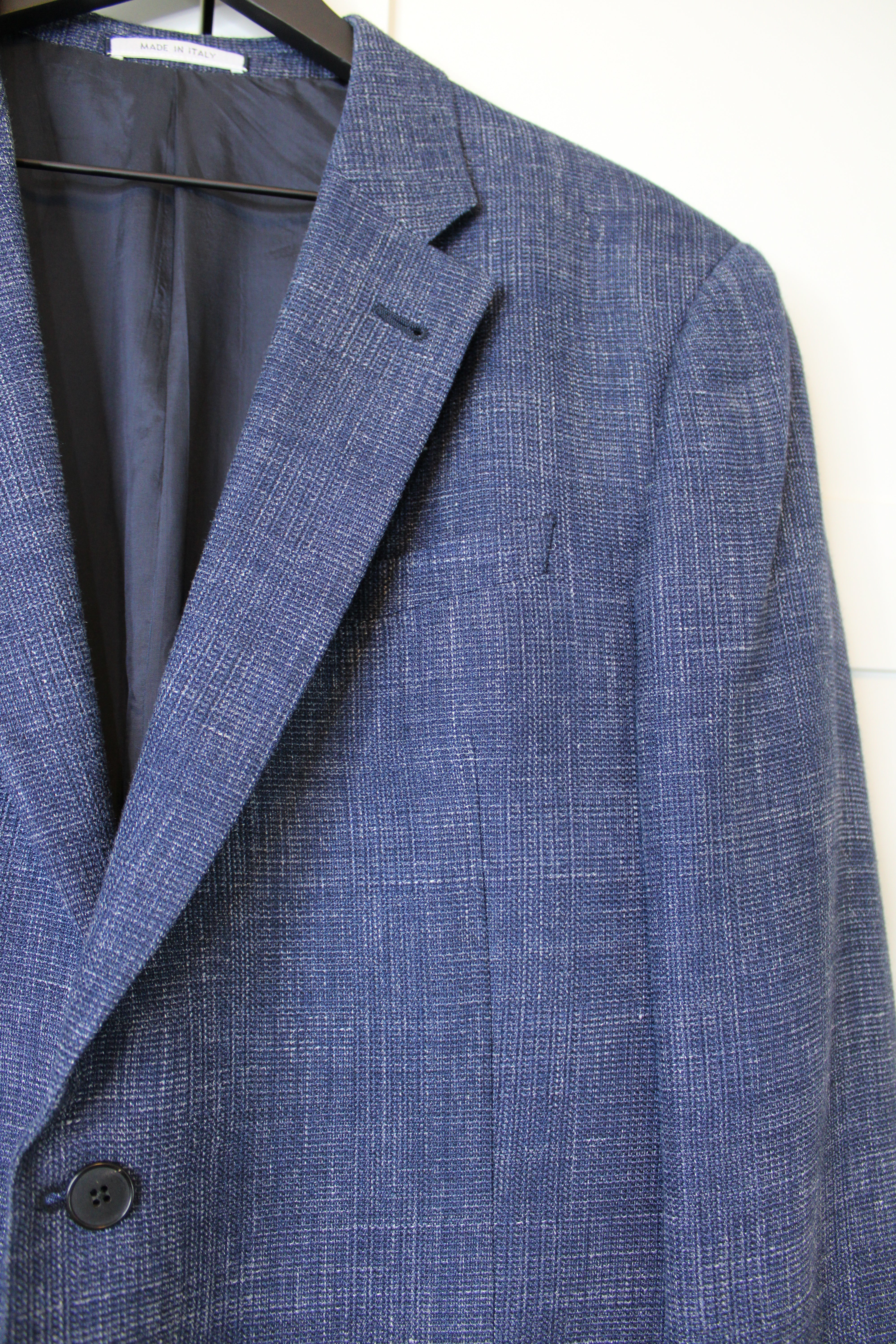 Close-up of a blue checkered suit jacket on a white background