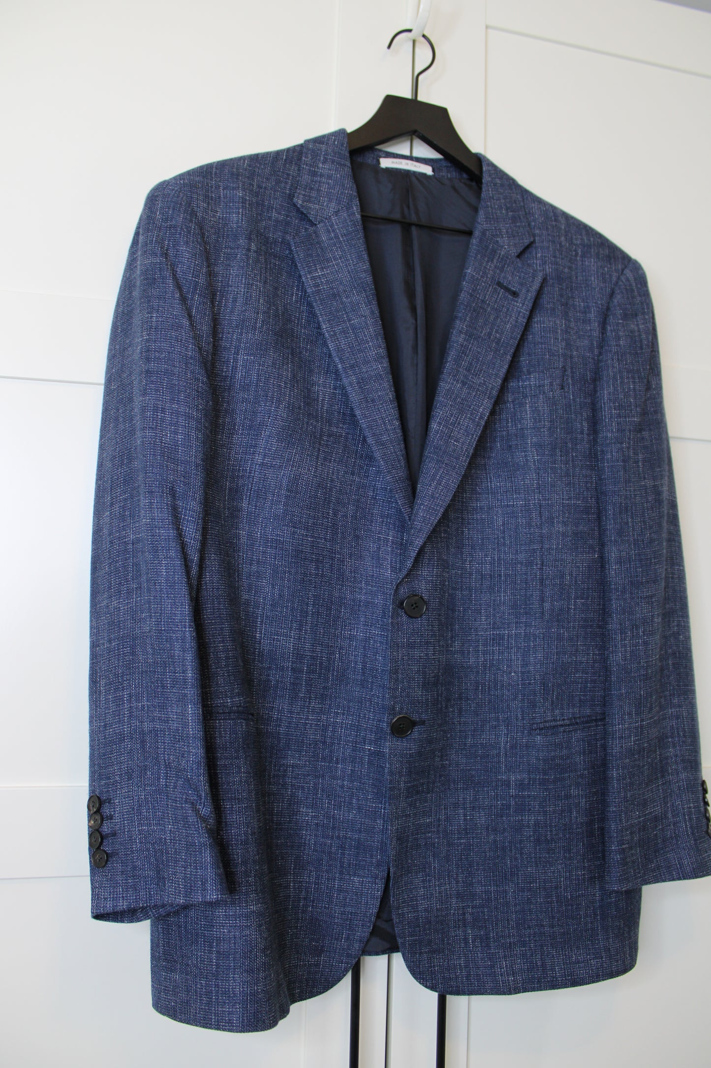 Blue suit jacket on a white background