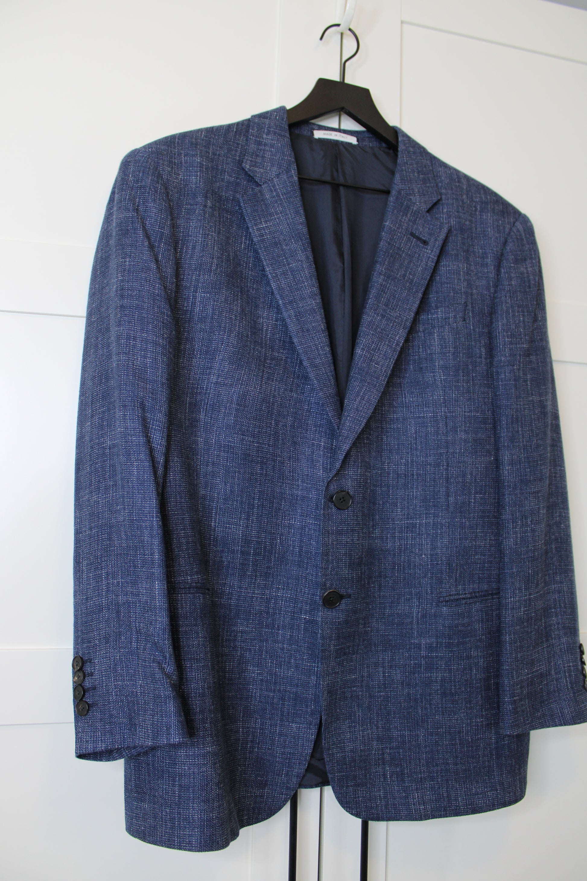 Blue suit jacket on a white background